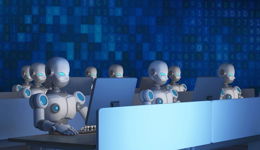 humanoid robots sitting at computer screens